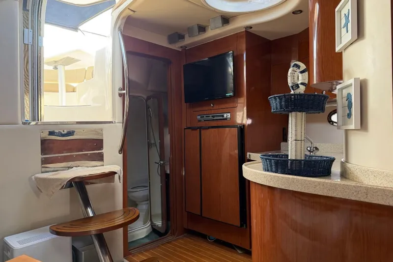 Slide: The Image of Interior of 2005 Regal Commodore 3860 yacht with wooden cabinetry and modern amenities. - 23