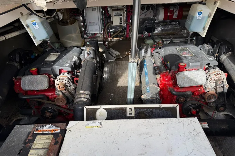 Slide: The Image of Engine compartment of a 2005 Regal Commodore 3860 boat, featuring dual engines. - 24
