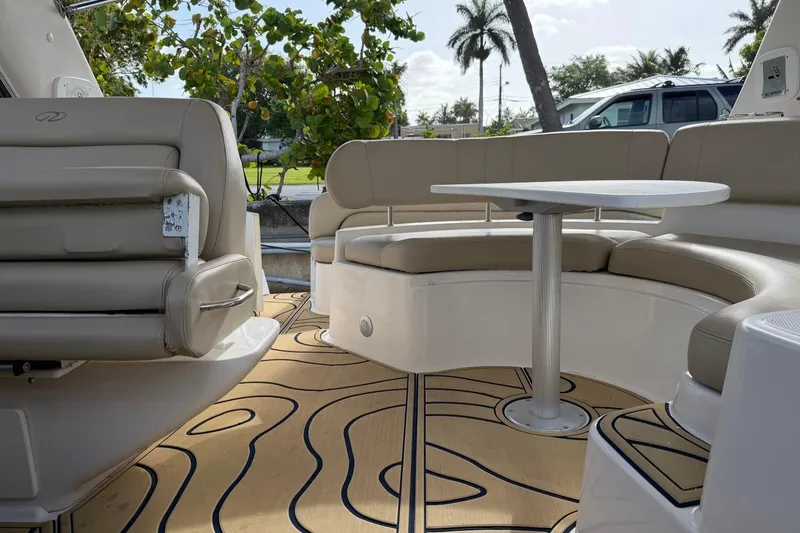 Slide: The Image of 2005 Regal Commodore 3860 boat interior with beige seating and table, featuring stylish flooring. - 5