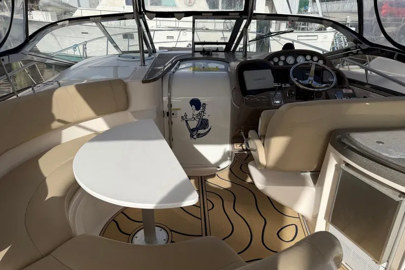 Slide: The Image of Interior of 2005 Regal Commodore 3860 yacht with seating, table, and helm. - 6