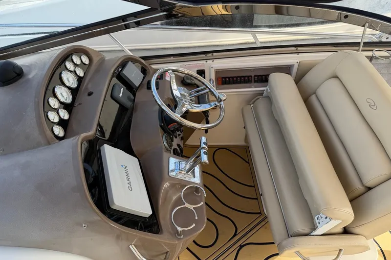 Slide: The Image of Helm of 2005 Regal Commodore 3860 with Garmin navigation and beige seating. - 9