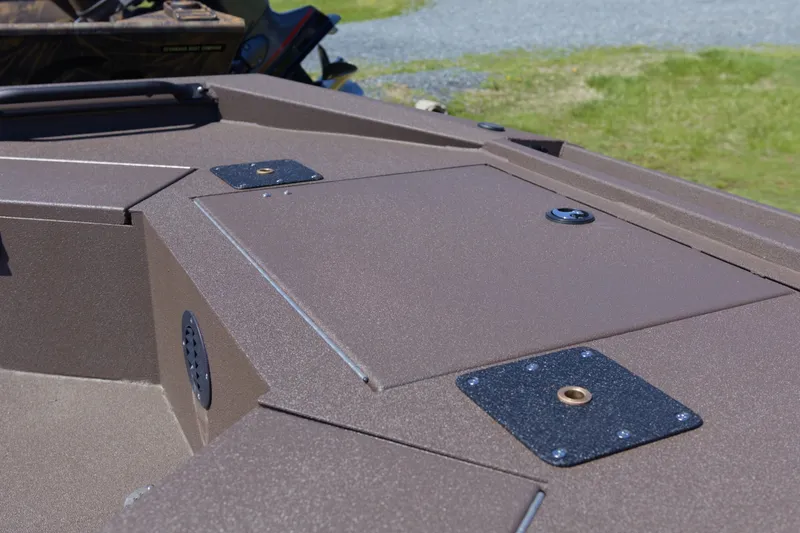 Slide: The Image of 2026 Avid 18 Commander boat deck with storage compartments and rugged design. - 10