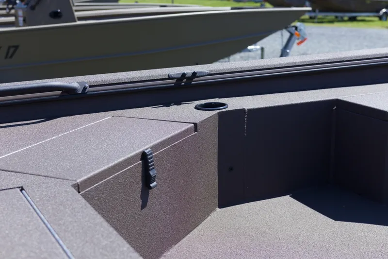 Slide: The Image of 2026 Avid 18 Commander boat interior with storage compartment and cup holder. - 11