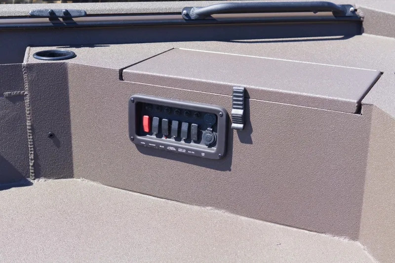 Slide: The Image of Control panel on 2026 Avid 18 Commander boat, featuring switches and textured surface. - 4