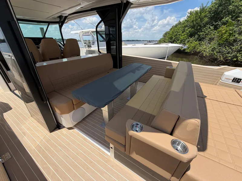 Slide: The Image of The image shows the deck of a 2027 Saxdor 400 GTS with beige seating and a table. - 17