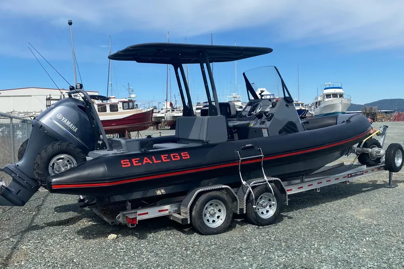 The Image of 2024 Sealegs 7.5 boat on trailer, featuring Yamaha engine, in a marina setting. - 0