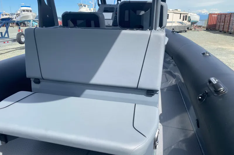 Slide: The Image of 2024 Sealegs 7.5 boat interior with gray seating and control panel. - 11