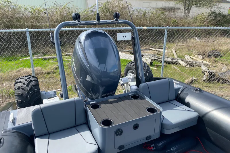 Slide: The Image of 2024 Sealegs 7.5 boat with Yamaha engine, featuring seating and storage, parked outdoors. - 15