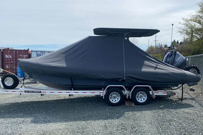 Slide: The Image of 2024 Sealegs 7.5 boat covered on trailer, parked outdoors. - 16