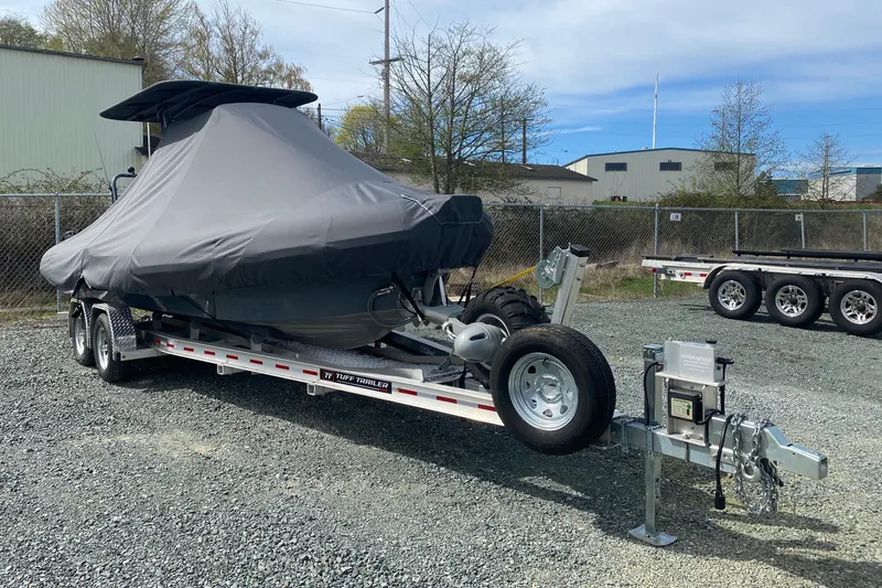 Slide: The Image of 2024 Sealegs 7.5 boat covered on a trailer in a gravel lot. - 18