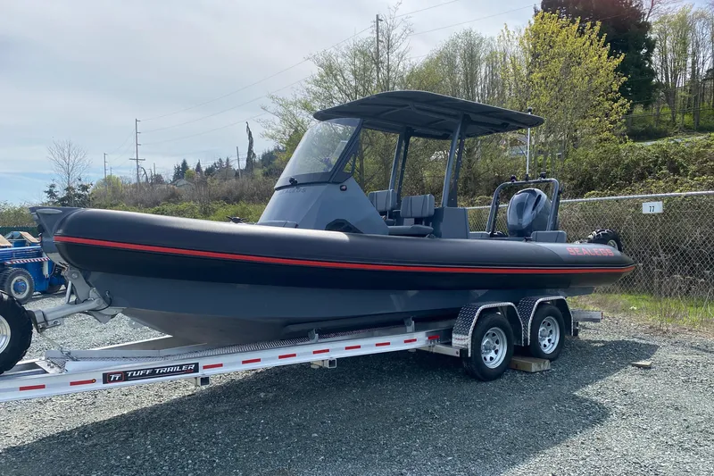 Slide: The Image of 2024 Sealegs 7.5 boat on trailer, parked outdoors, featuring sleek design and modern features. - 2