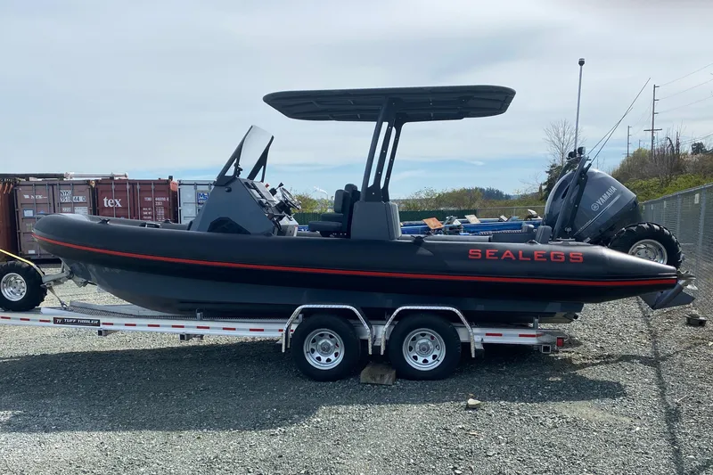Slide: The Image of 2024 Sealegs 7.5 boat on trailer, featuring Yamaha engine, parked outdoors. - 3