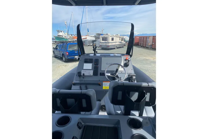 Slide: The Image of 2024 Sealegs 7.5 boat dashboard with steering wheel and control panel. - 7