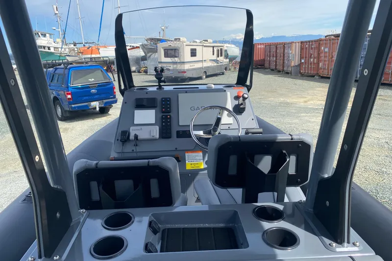 Slide: The Image of 2024 Sealegs 7.5 boat dashboard with steering wheel and navigation equipment. - 8