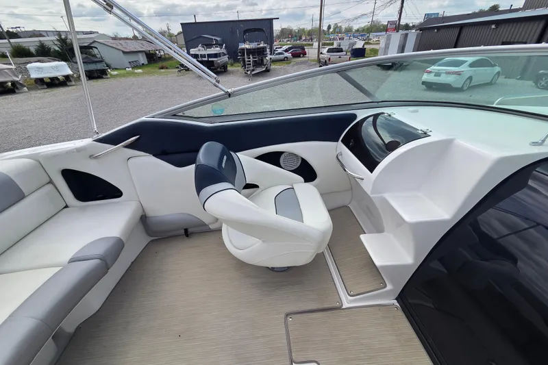 Slide: The Image of 2016 Rinker 236 Captiva Cuddy boat interior with seating and helm. - 10