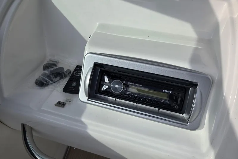 Slide: The Image of Sony stereo system on 2016 Rinker 236 Captiva Cuddy boat dashboard. - 13
