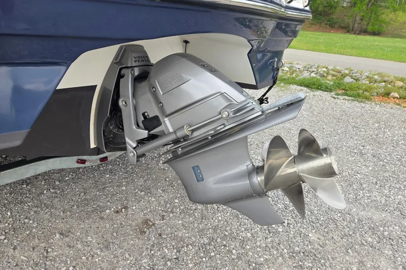 Slide: The Image of 2016 Rinker 236 Captiva Cuddy boat with Volvo Penta outdrive on gravel surface. - 18