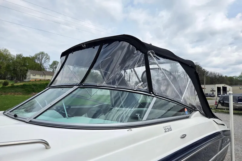 Slide: The Image of 2016 Rinker 236 Captiva Cuddy boat with canopy, parked outdoors. - 20