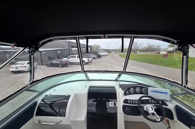 Slide: The Image of Interior view of 2016 Rinker 236 Captiva Cuddy boat with dashboard and steering wheel. - 21