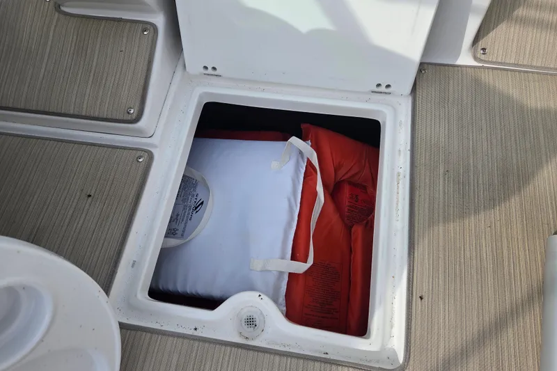 Slide: The Image of Storage compartment on 2016 Rinker 236 Captiva Cuddy with life jackets inside. - 22