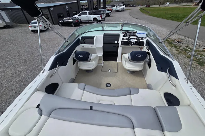 Slide: The Image of 2016 Rinker 236 Captiva Cuddy boat interior with seating and steering console. - 5
