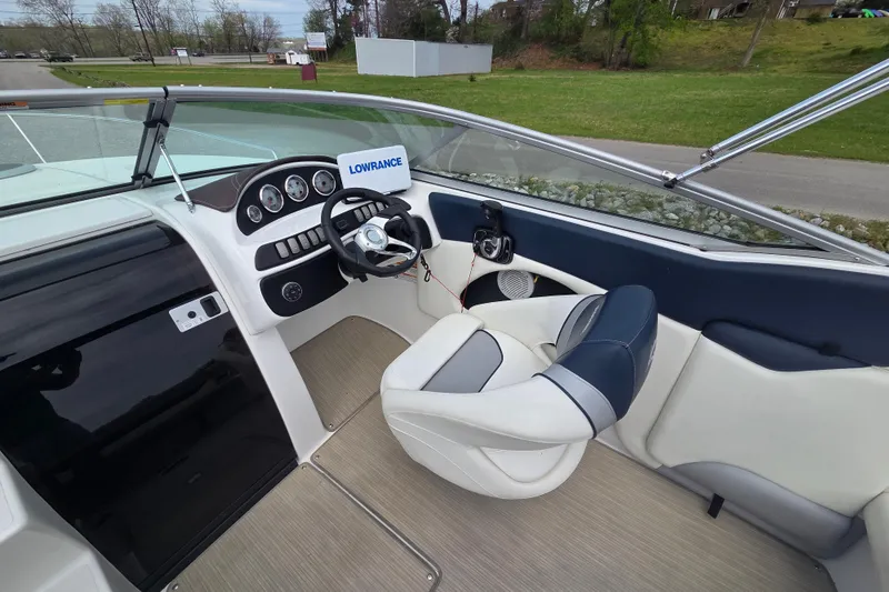 Slide: The Image of 2016 Rinker 236 Captiva Cuddy boat interior with steering wheel and dashboard. - 9