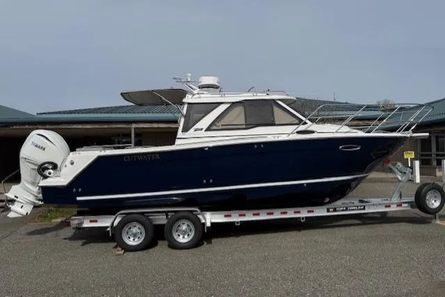 The Image of 2026 Cutwater C-248 Coupe boat on trailer, featuring sleek design and Yamaha engine. - 0
