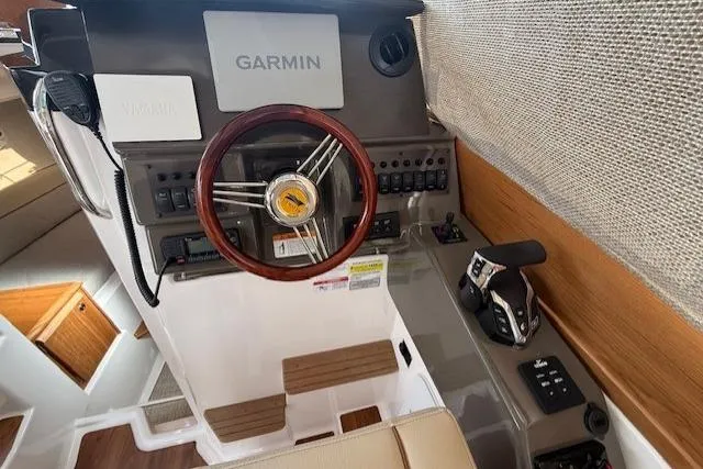 Slide: The Image of Helm of 2026 Cutwater C-248 Coupe with Garmin navigation and wooden steering wheel. - 10