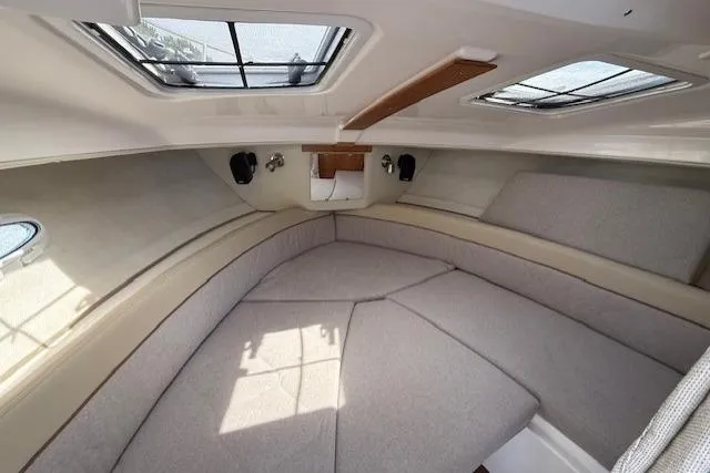 Slide: The Image of Interior of 2026 Cutwater C-248 Coupe boat, featuring cozy seating and overhead windows. - 11