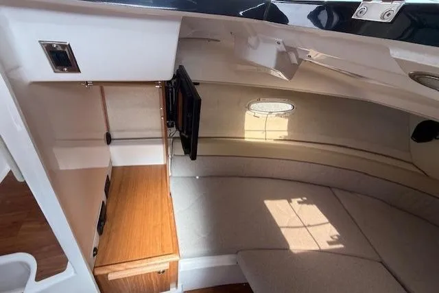 Slide: The Image of Interior cabin of 2026 Cutwater C-248 Coupe, featuring cozy seating and wooden cabinetry. - 12