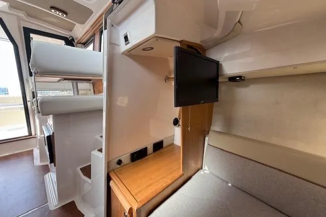 Slide: The Image of Interior of 2026 Cutwater C-248 Coupe featuring seating, TV, and modern design elements. - 13