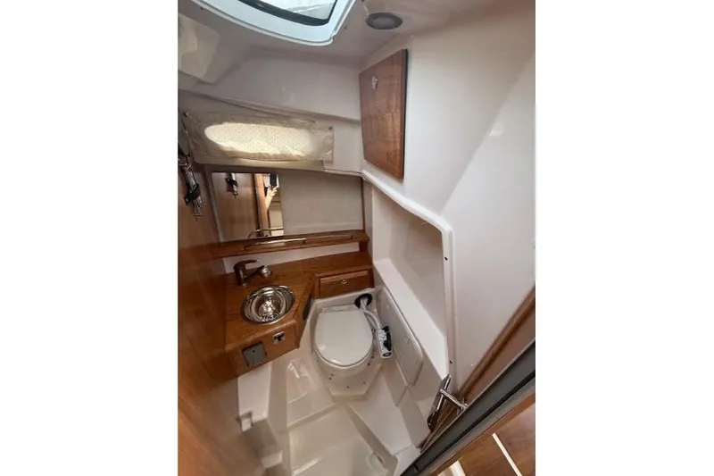 Slide: The Image of Interior of 2026 Cutwater C-248 Coupe boat bathroom with sink and toilet. - 14