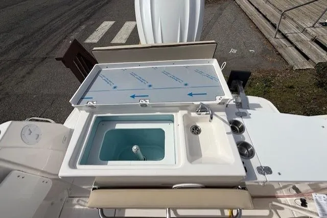 Slide: The Image of 2026 Cutwater C-248 Coupe boat deck with sink and storage compartment. - 16