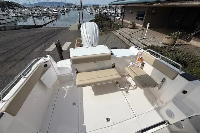 Slide: The Image of 2026 Cutwater C-248 Coupe boat interior with beige seating, docked at marina. - 4