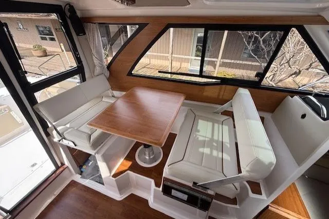 Slide: The Image of Interior of 2026 Cutwater C-248 Coupe featuring a cozy dining area with wooden table. - 5