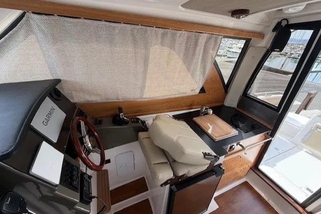 Slide: The Image of Interior of 2026 Cutwater C-248 Coupe boat with helm, seating, and navigation equipment. - 8