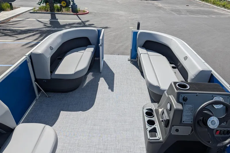 Slide: The Image of 2026 Sun Tracker Party Barge 16 DLX pontoon boat interior with seating and helm. - 6