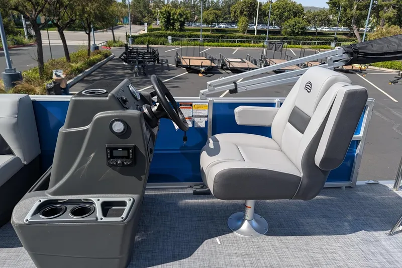 Slide: The Image of 2026 Sun Tracker Party Barge 16 DLX helm with comfortable captain's chair and control panel. - 8