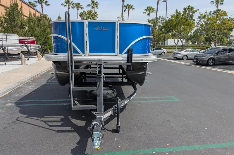 Slide: The Image of 2026 Sun Tracker Party Barge 18 DLX pontoon boat in parking lot. - 2