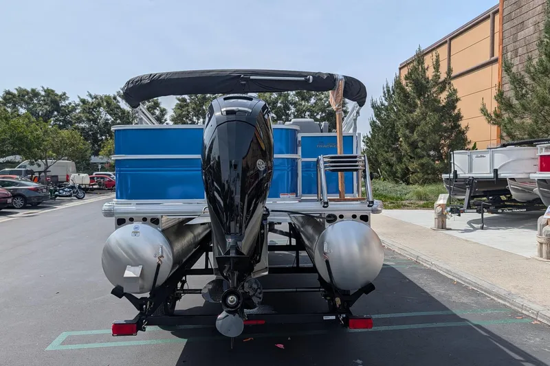 Slide: The Image of 2026 Sun Tracker Party Barge 18 DLX pontoon boat with outboard motor in parking lot. - 3