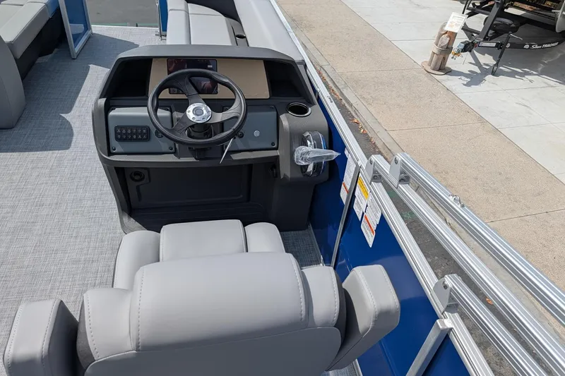 Slide: The Image of 2026 Sun Tracker Party Barge 18 DLX boat interior with steering console and seating. - 5