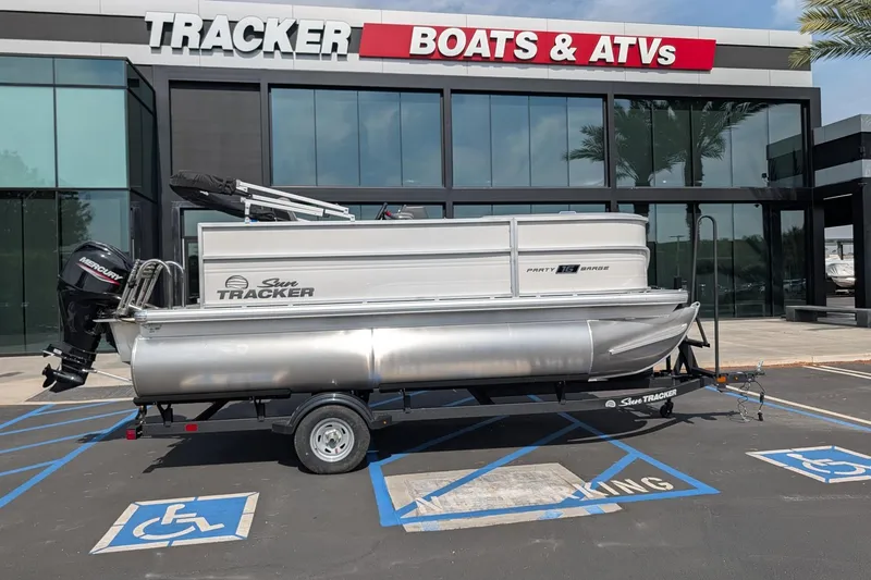 The Image of 2026 Sun Tracker Party Barge 16 DLX pontoon boat outside Tracker Boats dealership. - 0
