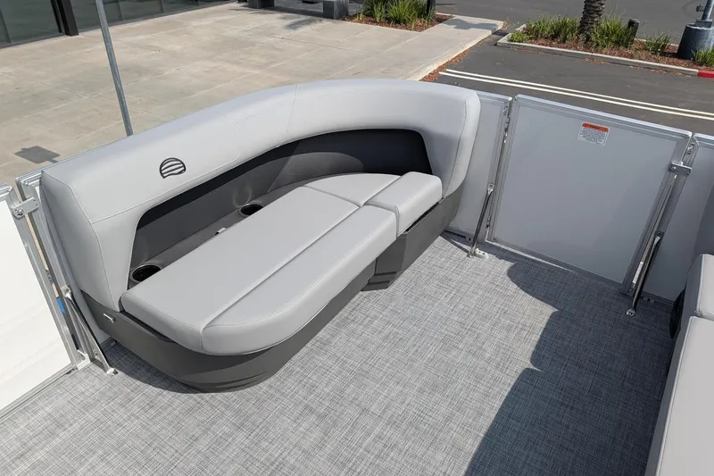 Slide: The Image of 2026 Sun Tracker Party Barge 16 DLX interior with gray seating and cup holders. - 8