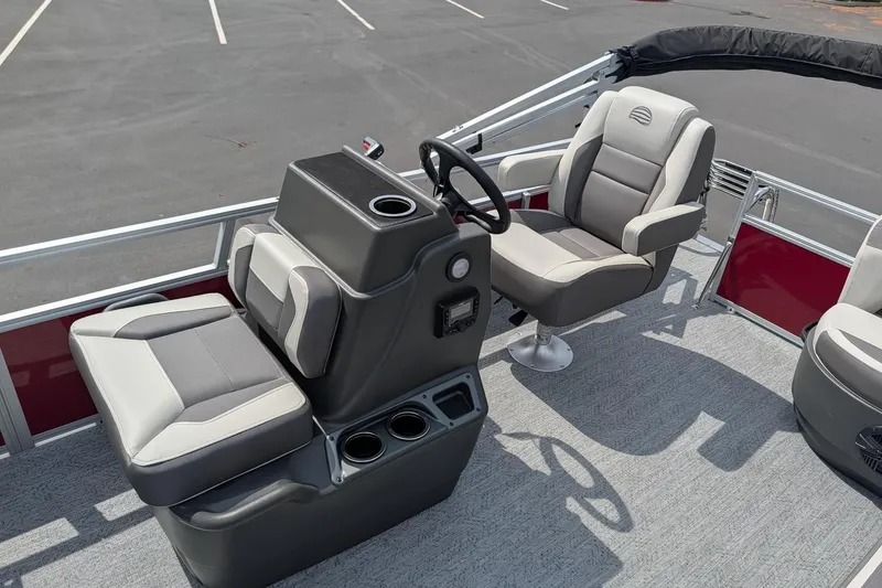 Slide: The Image of 2026 Sun Tracker Bass Buggy 16 XL Select boat interior with steering console and seating. - 11