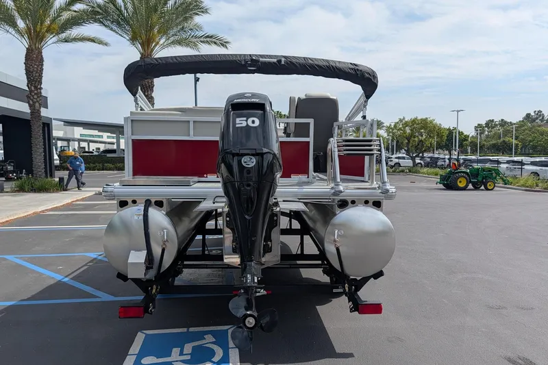 Slide: The Image of 2026 Sun Tracker Bass Buggy 16 XL Select pontoon boat with Mercury 50 engine in parking lot. - 5