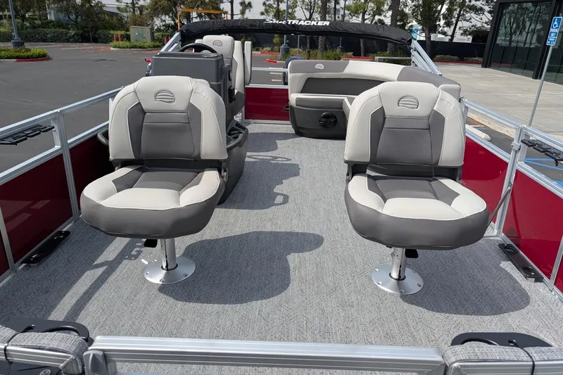 Slide: The Image of 2026 Sun Tracker Bass Buggy 16 XL Select pontoon boat interior with seating and steering console. - 7