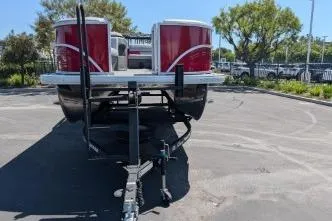 Slide: The Image of 2026 Sun Tracker Party Barge 20 DLX pontoon boat on trailer in parking lot. - 3
