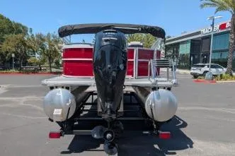 Slide: The Image of 2026 Sun Tracker Party Barge 20 DLX pontoon boat, rear view in parking lot. - 4