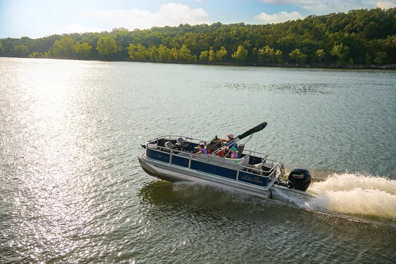 Slide: The Image of 2026 Sun Tracker Bass Buggy 18 DLX pontoon boat on trailer in parking lot. - 3