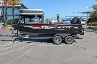 The Image of 2026 Tracker Targa V-18 WT boat on trailer in parking lot, side view. - 0